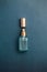 Face serum bottle with face creams, face oil capsules on teal blue background. cosmetics flat lay