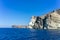 Face shaped rock on the blue sea