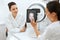 Face Skin Analyze. Cosmetologist Analyzing Woman Facial Skin