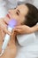 Face Skin Cosmetology. Closeup Woman Doing Blue Light Treatment