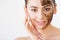 Face Skincare. Young charming girl makes a black charcoal mask o