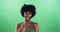 Face, smile and black woman with thumbs up on green screen in studio isolated on background mockup. Portrait, hand