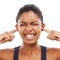 Face, sound and fingers in ears with an eyes closed woman in studio isolated on a white background. Stress, anxiety or