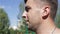 Face of the sportsman with a drops of the sweat on the blue sky background.