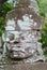 Face of a stone carved demon at the Angkor Thom temple South gate in Siem Reap, Cambodia.