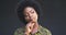 Face, thinking and a young woman with a decision, choice and afro hair on a grey background. Portrait, african and idea