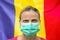 Face of a woman in a mask looking at the camera against the background of the Moldova flag. Influenza from coronavirus, prevention