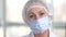 Face of woman surgeon in face mask.