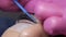 Face of young girl before eyelash lamination procedure in a professional beauty salon. The master washes off the black