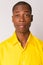 Face of young handsome bald African businessman wearing yellow shirt