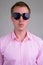 Face of young handsome businessman wearing heart shape sunglasses