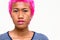 Face of young rebellious Asian woman with pink hair and nose piercing