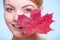 Face of young woman girl with red maple leaf