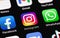 Facebook, Instagram, WhatsApp - social media app icons, messengers on screen smartphone iPhone closeup