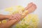 Faceless beautiful young woman takes a bath with milk lemons and lime. Cropped photo. Close-up of female hands and feet