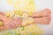 Faceless beautiful young woman takes a bath with milk lemons and lime. Cropped photo. Close-up of female hands and feet