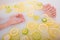 Faceless beautiful young woman takes a bath with milk lemons and lime. Cropped photo. Close-up of female hands and feet