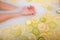 Faceless beautiful young woman takes a bath with milk lemons and lime. Cropped photo. Close-up of female hands and feet