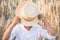 Faceless. cute kid boy covers his face straw hat  on wheat field.  A child walks outside in the countryside. Lifestyle