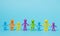 Faceless family on blue background. Stay at home concept. Multi-colored figures of people near the house