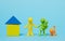 Faceless family on blue background. Stay at home concept. Multi-colored figures of people near the house