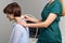 Faceless female sonographer examing neck. Healthcare worker doing ultrasound scanning