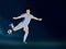 Faceless Footballer Player Kicking Ball On Blue Background