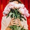A faceless girl holds a bouquet of peonies. Soft focus.