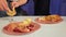 A faceless Jewish family near the festive table of Rosh Hashana is dipping an apple in honey