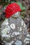 Faceless Jizo Bosatsu statue wearing red cap