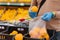 Faceless man buyer chooses fresh oranges in shopping mall, afraids of coronavirus, wears rubber gloves during virus outbreak, buys