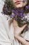 Faceless portrait of woman holding purple flowers