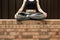 Faceless portrait of young female sitting in lotus position