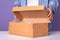 Faceless portrait of young man wearing denim shier and white shier opens brown carton box with present for his birthday, gift in