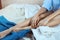 Faceless shot of woman`s hands and legs on a bed