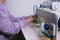 Faceless shot of woman working with sewing machine in her workshop