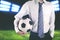 Faceless soccer club manager wearing tie and holding soccer ball