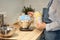 Faceless woman cooking and baking dough on kitchen table at home,