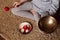 Faceless woman meditates at home on carpet and plays on copper singing bowl. Yoga and healthy lifestyle