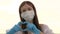 A faceless woman in a protective mask and medical gloves shows a heart symbol with her hands. Young woman loves doctors