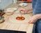 Faceless woman topping Rustic Italian homemade Pizza Dough margherita. Homemade food