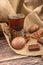 A faceted glass of tea in a vintage Cup holder, chocolate gingerbread and chocolate on a background of rough homespun fabric.