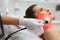 Facial Beauty Treatment. Woman Doing Red Led Light Therapy