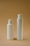 Facial and body care cosmetics bottles composition on brown background. Gel tube  lipstick  cream jar unbranded blank packages.