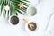 Facial clay mask and powder in bowls with tropical palm leaf on marble background. SPA natural organic cosmetic products for face