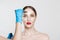 Facial cosmetic plastic surgery. Doctor surgeon hand in glove draw wrinkle lines on Woman face isolated white background.