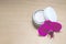 Facial cream and a flower on the wooden background