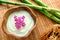 Facial Cream and Flowers in Wood Bowl in a Spa