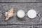 Facial cream and sea shell and stone on the wooden background