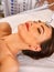 Facial massage at beauty salon. Electric stimulation woman skin care.